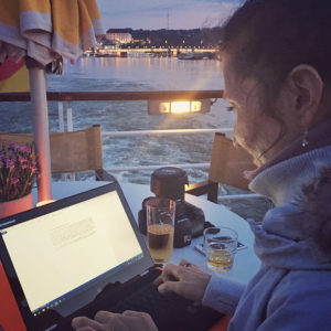 In der Abenddämmerung an Bord der Arosa Riva mit Laptop und Tee